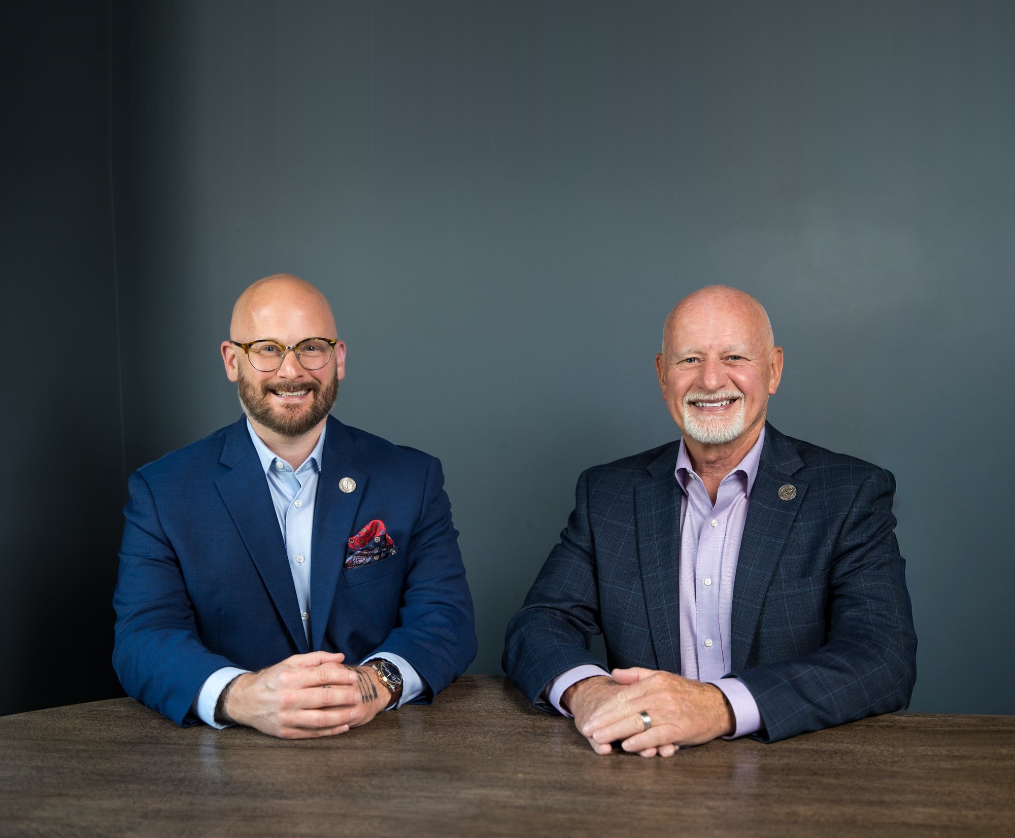 Ray and Justin Land, founders of MAX4 Claims Specialists, seated at their boardroom table